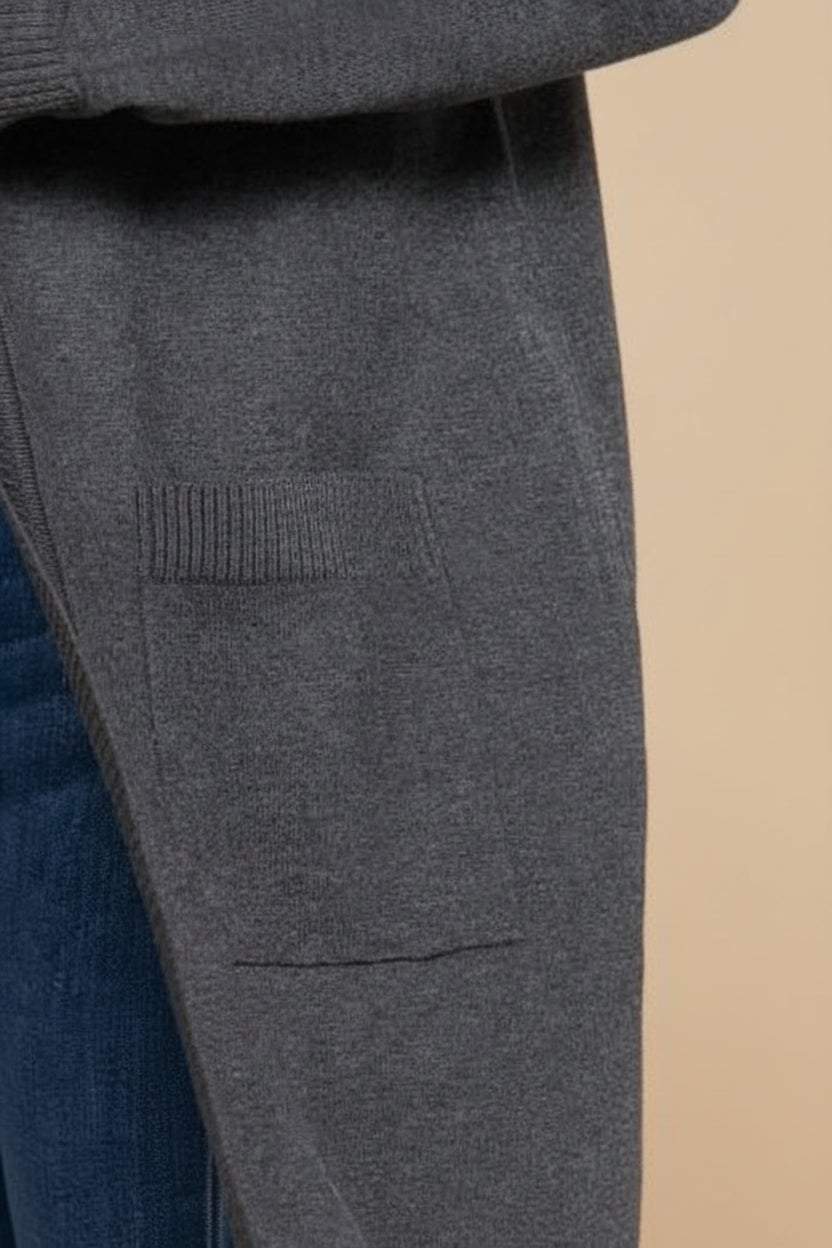 Close-up of gray pants with a pocket detail on a beige background