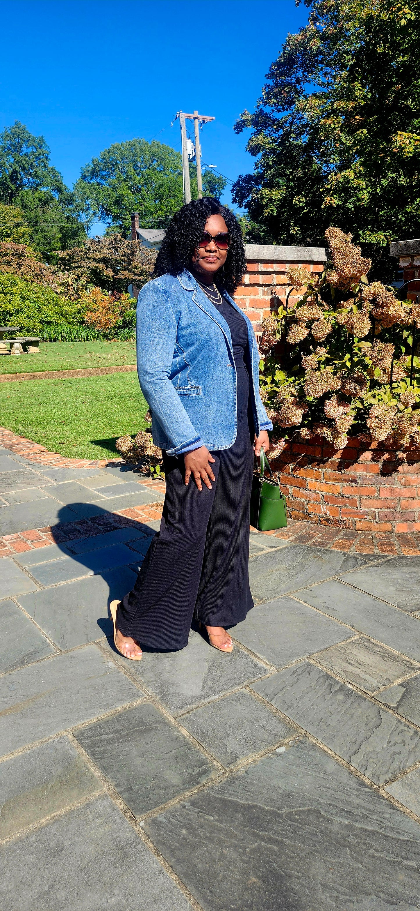 Woman standing on a stone path in a garden