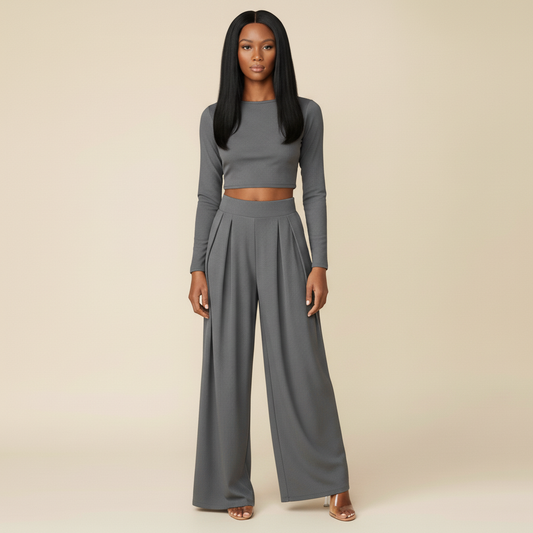 Woman wearing a gray long-sleeve top and wide-leg pants on a beige background