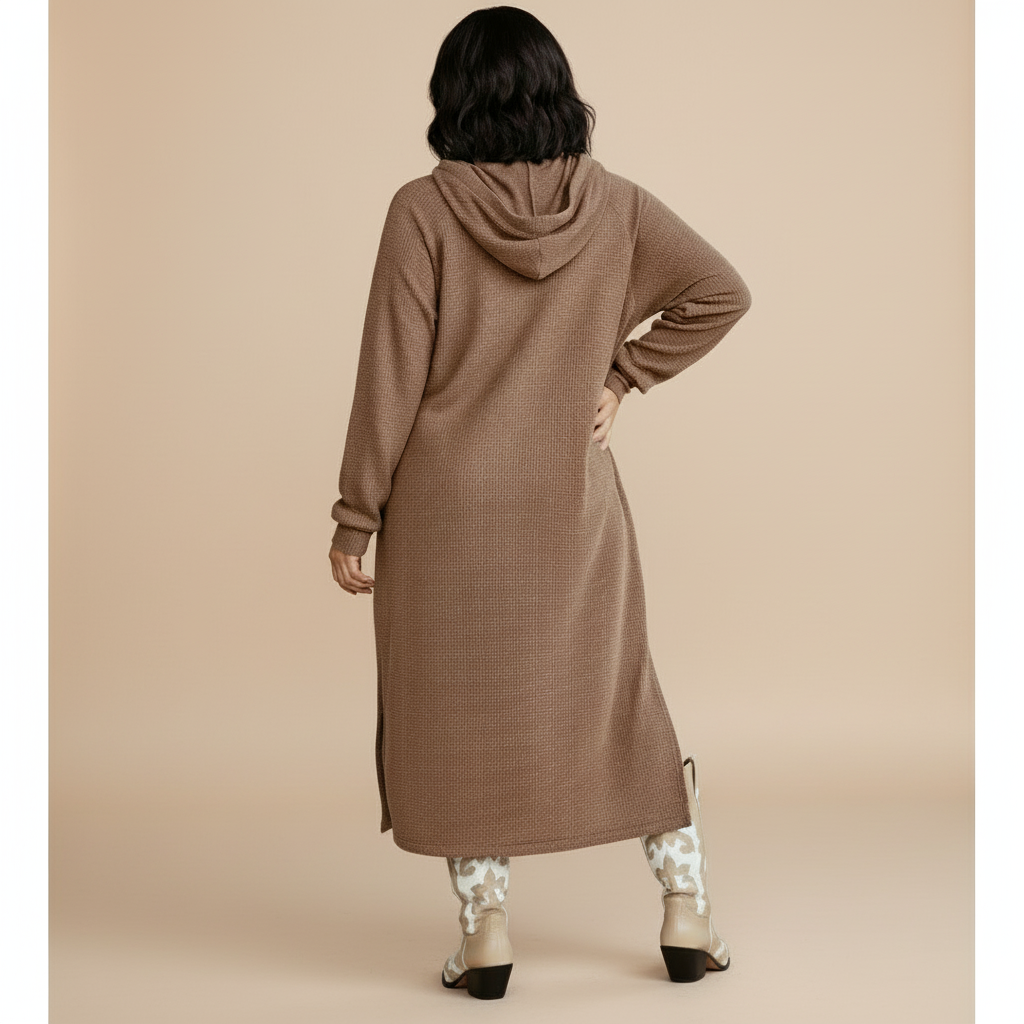 Woman wearing a long brown coat against a beige background