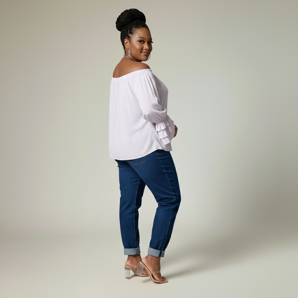 Woman wearing a lilac off-shoulder top and blue jeans on a plain background